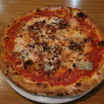 Giuseppe Pizza - a whole pizza on a white plate - Pizza Near Me - Montreal, Quebec Giuseppe Pizza - a whole pizza on a white plate - Pizza Near Me - Montreal, Quebec