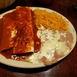 a plate of enchiladas and rice a plate of enchiladas and rice