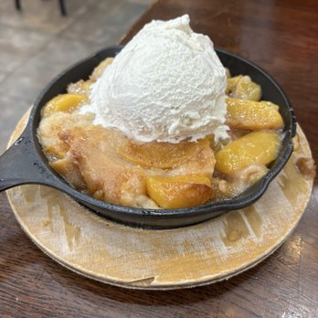 Pucketts - BNA Terminal D - Peach cobbler- like dessert (can't be peach cobbler because it did not have a crust!) - Barbeque Near Me - Nashville, Tennessee Pucketts - BNA Terminal D - Peach cobbler- like dessert (can't be peach cobbler because it did not have a crust!) - Barbeque Near Me - Nashville, Tennessee