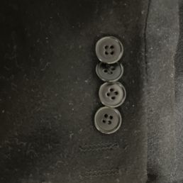 The buttons are not equidistant and one is about to pop off The buttons are not equidistant and one is about to pop off
