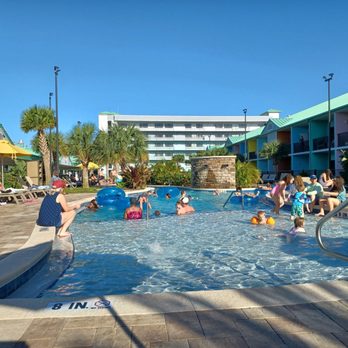 Beachside Hotel & Suites - The pool area with a shallow part for little kiddos,a deeper part, and always river was fantastic. There were always chairs available too! - Hotels Near Me - Cocoa Beach, Florida