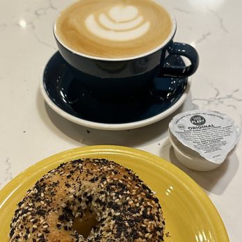 Rite Rite - a bagel on a yellow plate next to a cup of coffee - Coffee & Tea Near Me - Asheville, North Carolina Rite Rite - a bagel on a yellow plate next to a cup of coffee - Coffee & Tea Near Me - Asheville, North Carolina