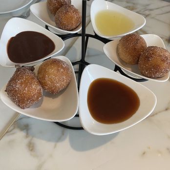 Spago - Doughnuts with chocolate, Carmel, and vanilla sauces - New American Near Me - Las Vegas, Nevada