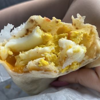 Heavenly Grind Coffee - a person holding a breakfast burrito - Coffee & Tea Near Me - Shawnee, Oklahoma Heavenly Grind Coffee - a person holding a breakfast burrito - Coffee & Tea Near Me - Shawnee, Oklahoma