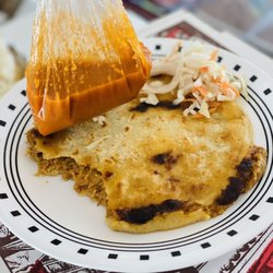 The Comida Latina Cuisine - Meat and cheese pupusa with cabbage and side sauce