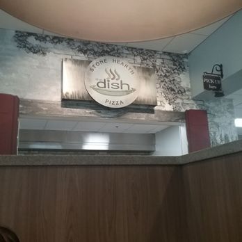 The Dish Restaurant - a woman sitting at a table - Pizza Near Me - Racine, Wisconsin The Dish Restaurant - a woman sitting at a table - Pizza Near Me - Racine, Wisconsin