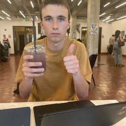 Me holding my blueberry lemonade. It is good and refreshing. I will most likely order a blueberry lemonade again some time in my life.