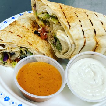 BayLeaf Bistro - a burrito with a side of sauce - Indian Near Me - Winnipeg, Manitoba