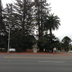 Padre Junipero Serra Redwood Bust - Wide shot of Junipero Serra redwood bust with S El Camino Real in foreground.