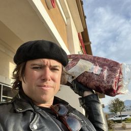 Me holding the meat I bought at the store, called Smart and final in Lake Forest Me holding the meat I bought at the store, called Smart and final in Lake Forest