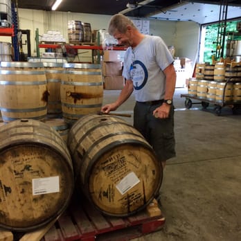 Smoky Quartz Distillery - a man standing in front of barrels - Beer, Wine & Spirits Near Me - Seabrook, New Hampshire