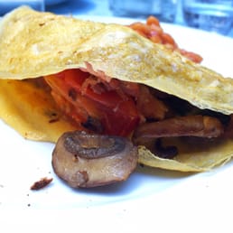 Omelette stuffed with mushrooms, ham, tomato and spinach