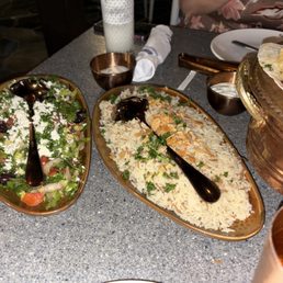 Salad and rice that comes with family meal.