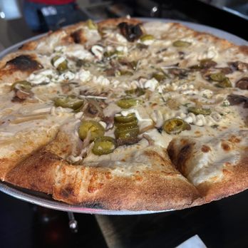 Fireside Pizza Cafe - White pizza with added toppings of mushroom, jalapeño and onion. - Pizza Near Me - Palm Harbor, Florida Fireside Pizza Cafe - White pizza with added toppings of mushroom, jalapeño and onion. - Pizza Near Me - Palm Harbor, Florida