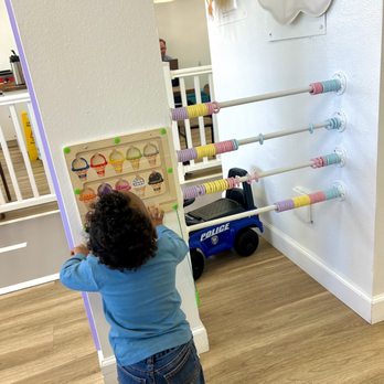 Family Barn - a toddler playing with toys - Playgrounds Near Me - Georgetown, Texas