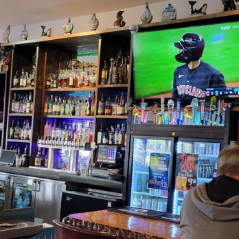 Harvey’s Tavern - a man watching a baseball game on tv - Lounges Near Me - Edmonds, Washington