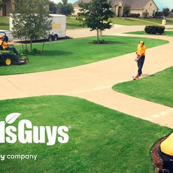 The Grounds Guys - a man mowing the lawn - Landscaping Near Me The Grounds Guys - a man mowing the lawn - Landscaping Near Me