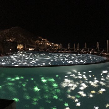 JK Travel & Tours - Pool at night in Greece - Travel Agents Near Me