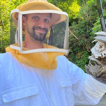 Fridays Pest Management - Using a Bee suit to remove a hornets nest - Pest Control Near Me