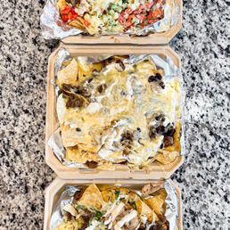 three trays of nachos
