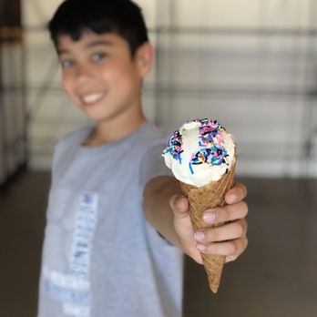 The Greenery Creamery - a boy holding an ice cream cone with sprinkles - Ice Cream & Frozen Yogurt Near Me - Sanford, Florida The Greenery Creamery - a boy holding an ice cream cone with sprinkles - Ice Cream & Frozen Yogurt Near Me - Sanford, Florida