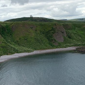 Dunnottar Castle - War Memorial on the hillside in the distance. - Landmarks & Historical Buildings Near Me
