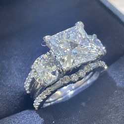 Collections Clothing Boutique - Customer 4 carat princess cut diamond GIA certified with 2) 1carat diamonds on each side set with a platinum diamond guard
