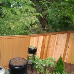 J & A fencing - neighbor's side & neighbor's old back fence. 6' wood 3 rail, 2x4 top & bottom cap & western red cedar boards.