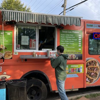Tacos Los Primos - a man ordering food from a food truck - Food Trucks Near Me - Arlington, Virginia