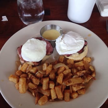 Counter Cafe East - Eggs Benedict on a biscuit with pastrami and egg.  Hollandaise sauce is on the side. - Breakfast & Brunch Near Me - Austin, Texas
