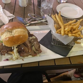 Prohibition Dunedin - Smoked brisket sandwich. Bruce enjoyed it more than I did (that's Brice under the fries). - Gastropubs Near Me - Dunedin, Florida
