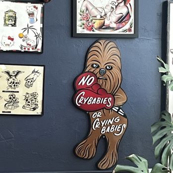 Royalty Tattoo Collective - Delightful sign in waiting space - Tattoo Near Me - Burlingame, California
