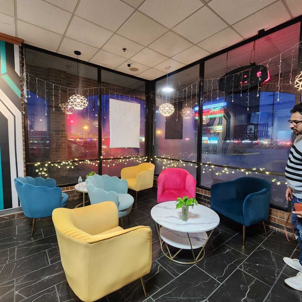SpecialTea - a man standing in a brightly colored lounge area - Bubble Tea Near Me - Naperville, Illinois SpecialTea - a man standing in a brightly colored lounge area - Bubble Tea Near Me - Naperville, Illinois