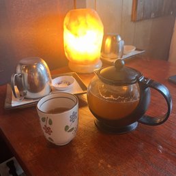 a teapot and a cup of tea on a table