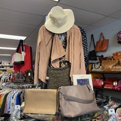 Rock It Resell - Comfort meets cool in this laid-back vignette: a buttery suede jacket on a cropped-hem sweater, paired with woven raffia cross-body.