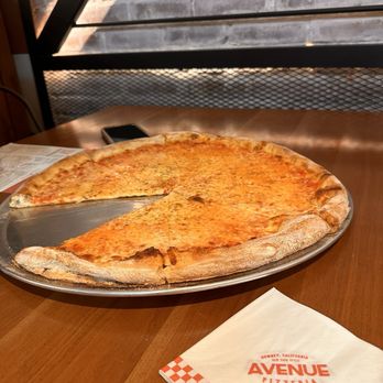 Avenue Pizzeria - a pizza with a slice taken out of it - Pizza Near Me - Downey, California