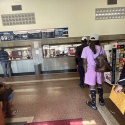 US Post Office - Line of people waiting, one window worker.