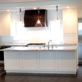 Weiss Construction - a kitchen with white cabinets and wood floors - General Contractors Near Me - Roseville, California Weiss Construction - a kitchen with white cabinets and wood floors - General Contractors Near Me - Roseville, California