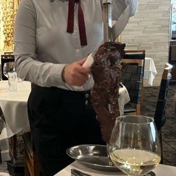 Fogo de Chão - Meat server carving steak - Brazilian Near Me - Pittsburgh, Pennsylvania