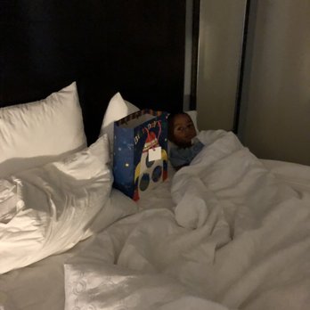 Staybridge Suites Phoenix - Chandler - He enjoyed his bday celebration at the hotel. Relaxing in the bed with a present - Hotels Near Me - Chandler, Arizona Staybridge Suites Phoenix - Chandler - He enjoyed his bday celebration at the hotel. Relaxing in the bed with a present - Hotels Near Me - Chandler, Arizona