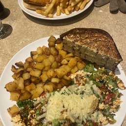 Broccoli, cheddar and roasted red pepper Tofu scramble with home fries & the Buffalo Chick'n (vegetarian) sandwich with French fries