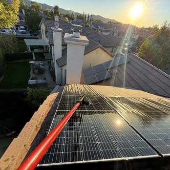 Blue Window Cleaner - Cleaning in progress - Gutter Services Near Me - Winnetka , California