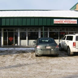two cars parked in front of the restaurant