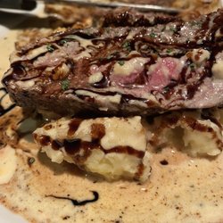 Steak over mashed  potatoes