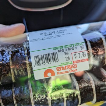 Super 1 Mart - a person holding a package of food - Grocery Near Me - La Palma, California