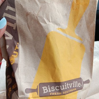 Biscuitville - a person holding a bag of biscuits - Breakfast & Brunch Near Me - Kings Mountain, North Carolina
