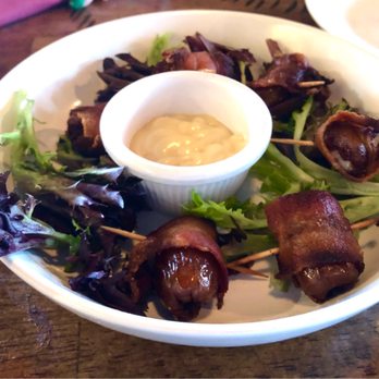 Essence Kitchen + Bar - Bacon-Wrapped Dates stuffed with blue cheese-- and maple syrup aioli sauce - New American Near Me - Chino Valley, Arizona Essence Kitchen + Bar - Bacon-Wrapped Dates stuffed with blue cheese-- and maple syrup aioli sauce - New American Near Me - Chino Valley, Arizona