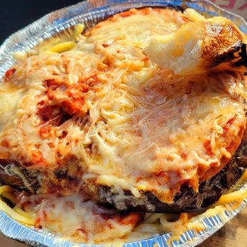 Rizza Pizza - Eggplant parm. Eggplant roasted, not breaded, topped w/fresh tomato, sauce, cheese, on a pile of spaghetti. - Pizza Near Me - Toledo, Oregon Rizza Pizza - Eggplant parm. Eggplant roasted, not breaded, topped w/fresh tomato, sauce, cheese, on a pile of spaghetti. - Pizza Near Me - Toledo, Oregon
