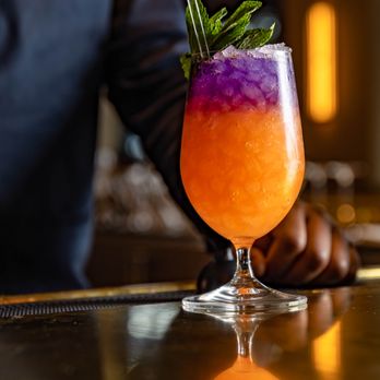 Harry's - a purple and orange drink on a bar - Seafood Near Me - West Palm Beach, Florida