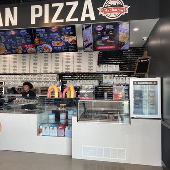 Manhattan Pizza - a woman standing in front of the counter - Sandwiches Near Me - Gainesville, Virginia